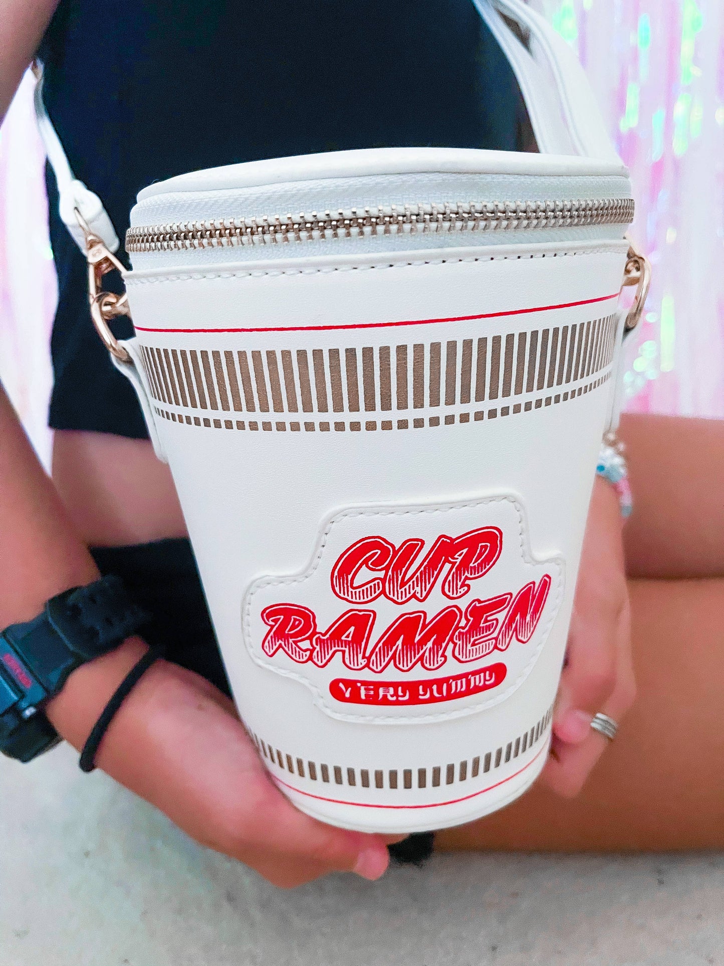 Girl Holding Cup of Noodles Purse Up Close