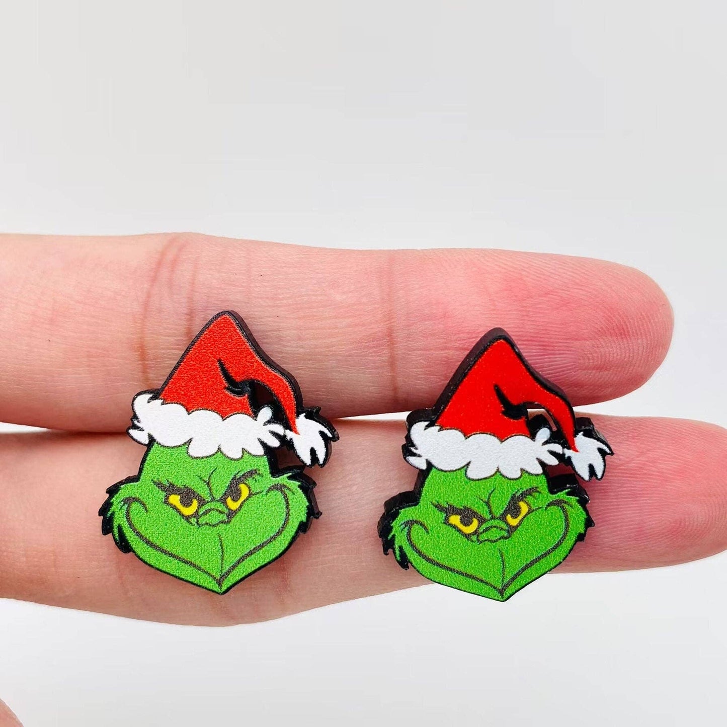 Grinch Head Stud Earrings in Hand