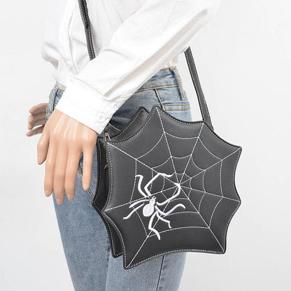 black spiderweb purse on model